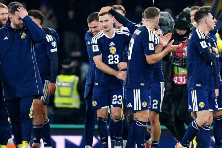 John McGinn celebrates Scotland's World Cup qualification from the corridor after drug test delay