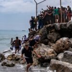 At least 18 dead as 49,000 migrants breach Morocco-Spain border in Ceuta surge